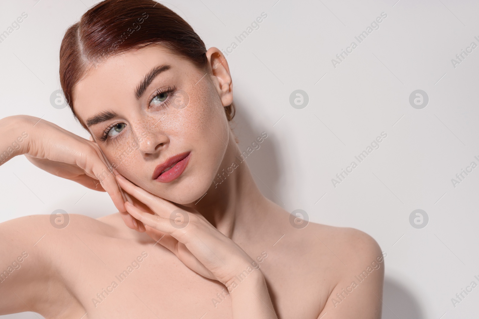Photo of Portrait of beautiful woman on light background, closeup. Space for text