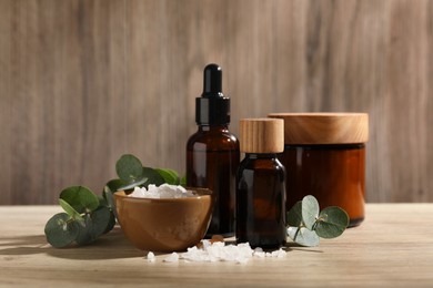 Composition with spa products and eucalyptus leaves on wooden table