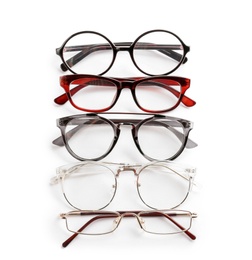 Photo of Different glasses with corrective lenses on white background. Vision problem