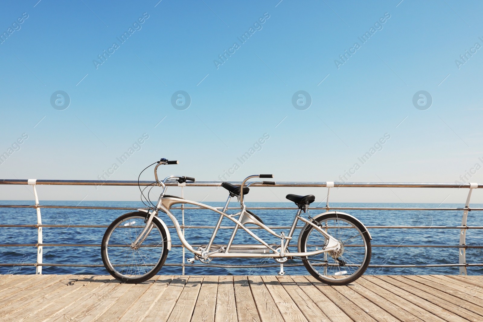 Photo of Tandem bike near sea on sunny day