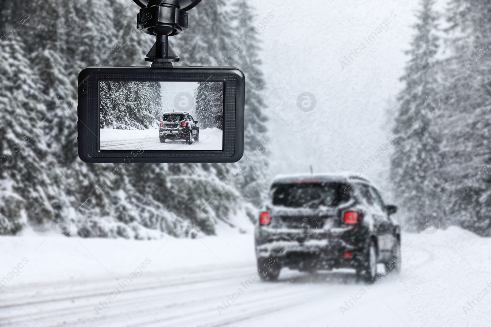 Image of Modern dashboard camera mounted in car, view of road during driving