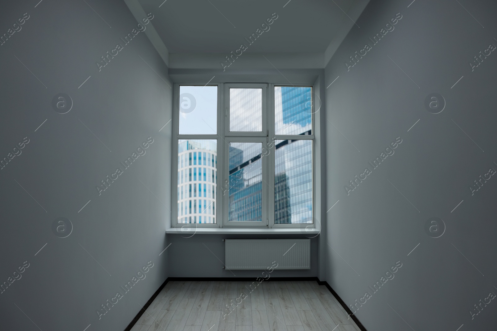 Photo of New empty room with clean windows and white walls