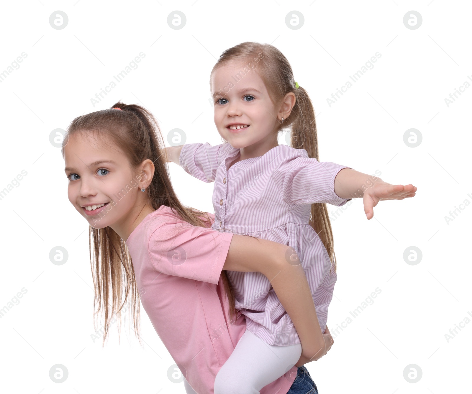 Photo of Portrait of cute little sisters on white background