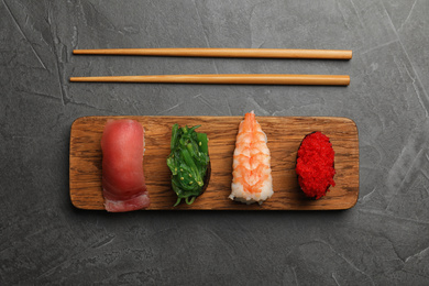 Photo of Set of delicious sushi on grey table, flat lay