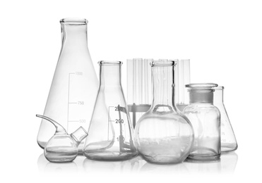 Photo of Set of empty laboratory glassware on white background