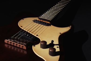 Electric guitar on black background, closeup. Musical instrument