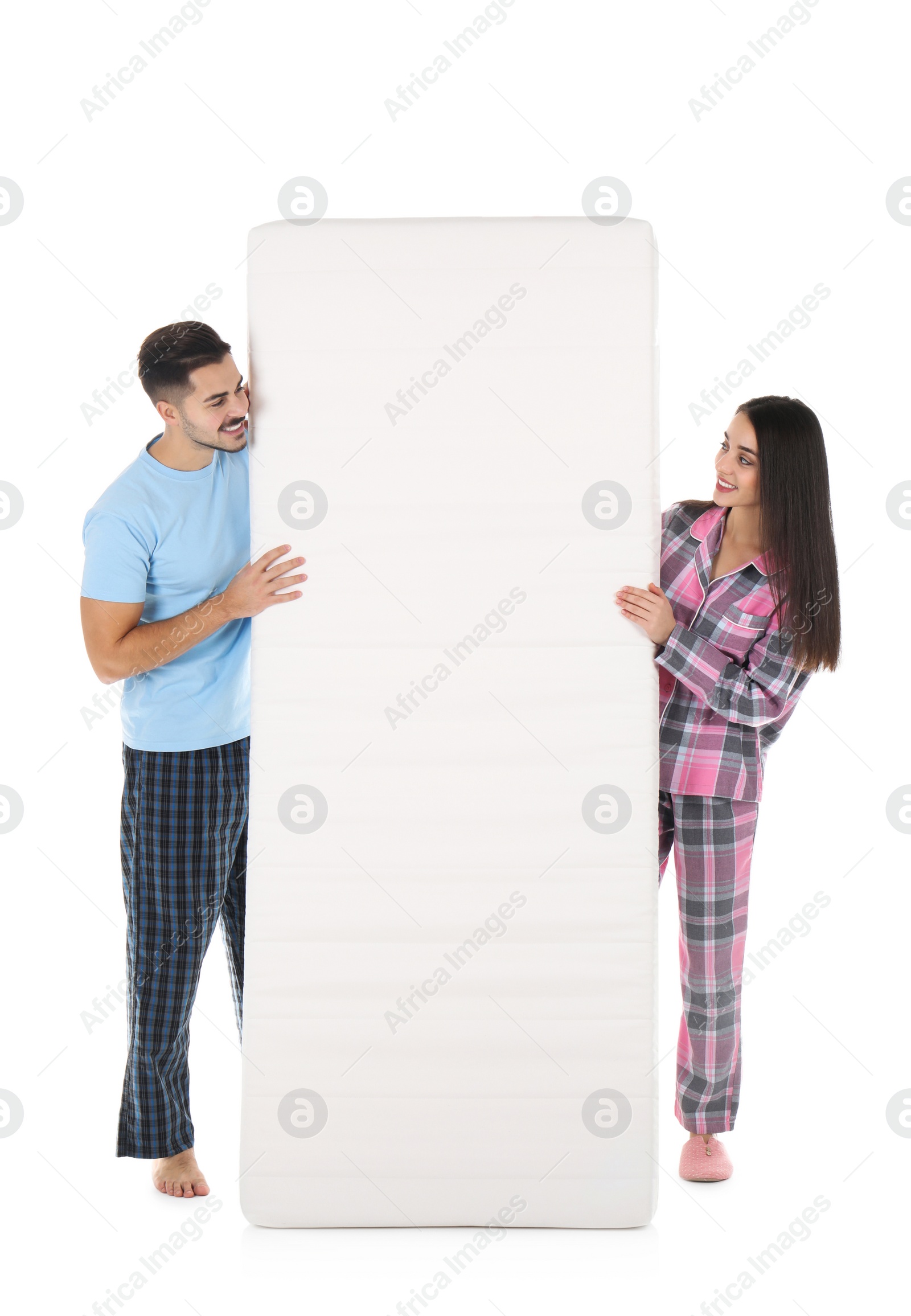 Photo of Young couple with comfortable mattress isolated on white