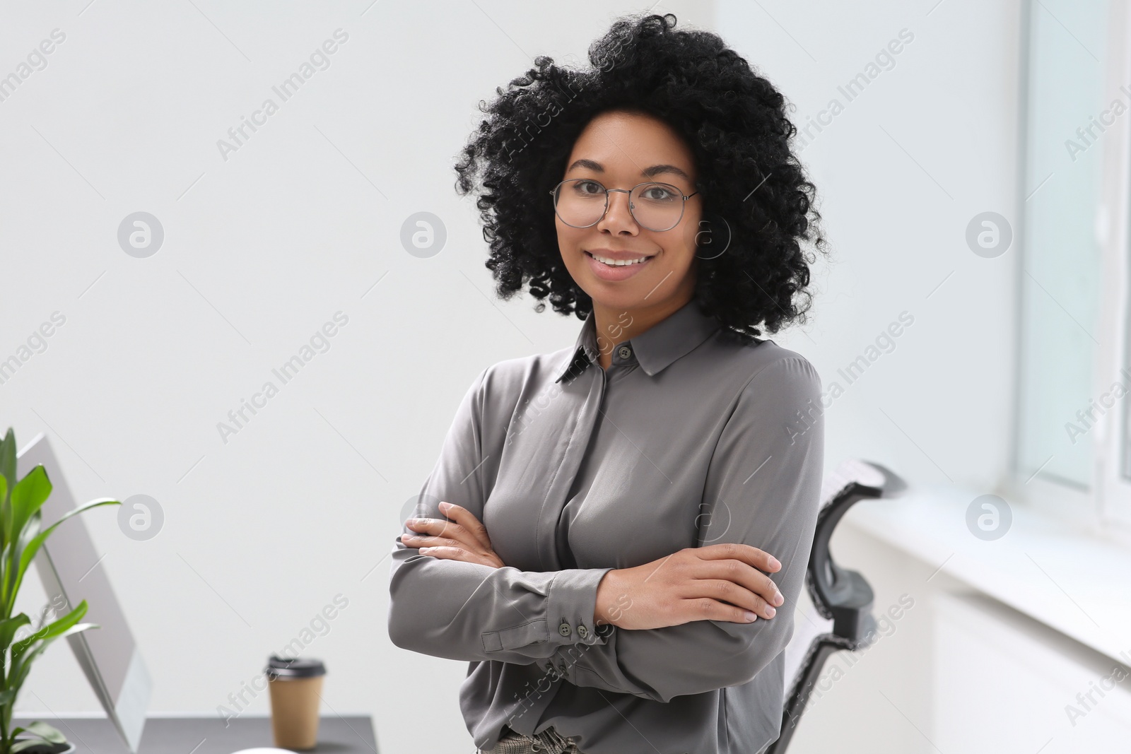 Photo of Smiling young businesswoman in her modern office