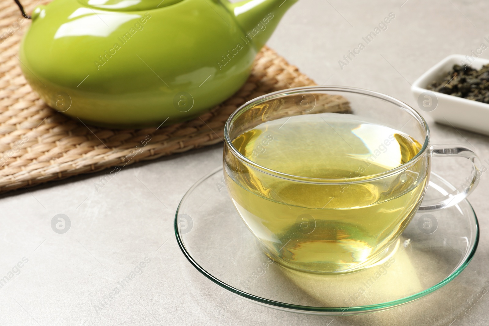 Photo of Glass cup of Tie Guan Yin oolong tea on table