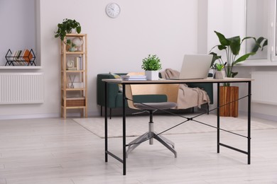 Workspace with cosy furniture and potted plants