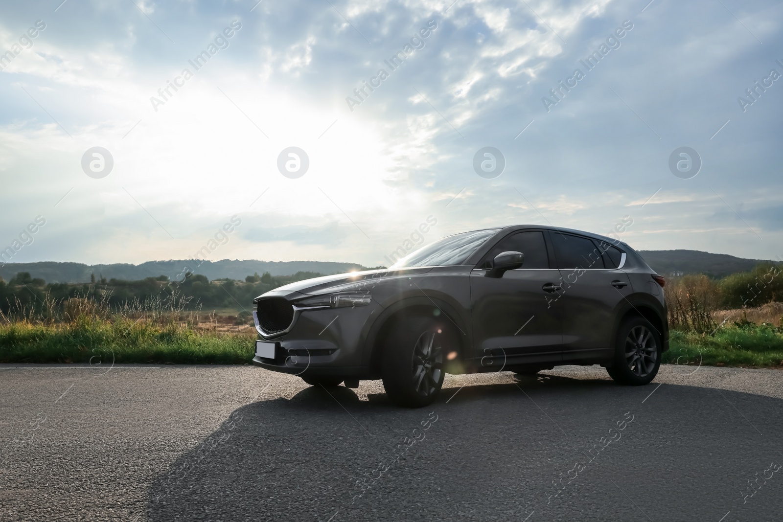 Photo of Black modern car parked on asphalt road