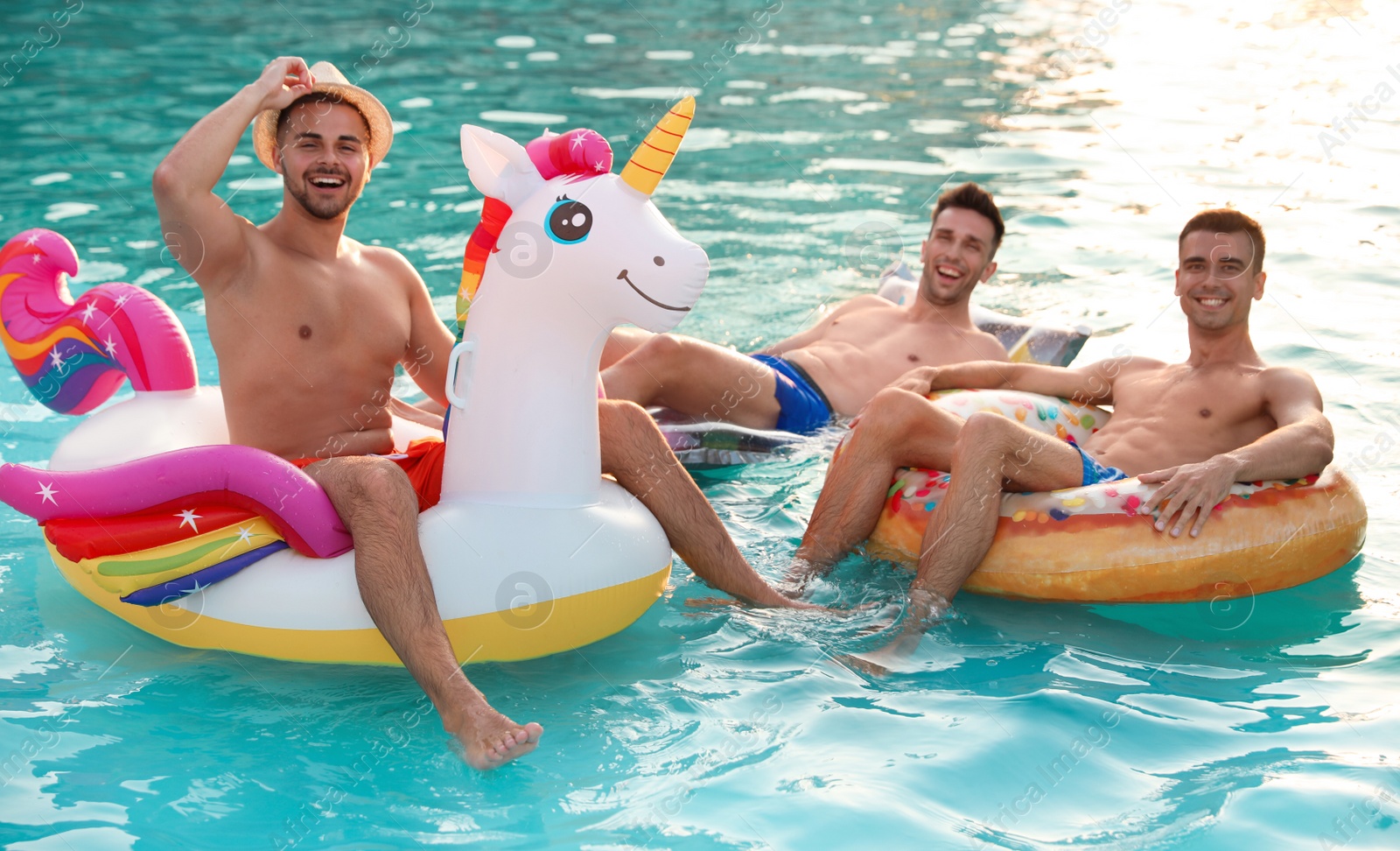 Photo of Happy young friends relaxing in swimming pool