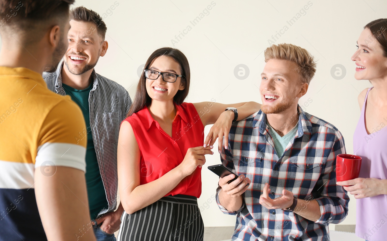 Photo of Group of happy people talking in office