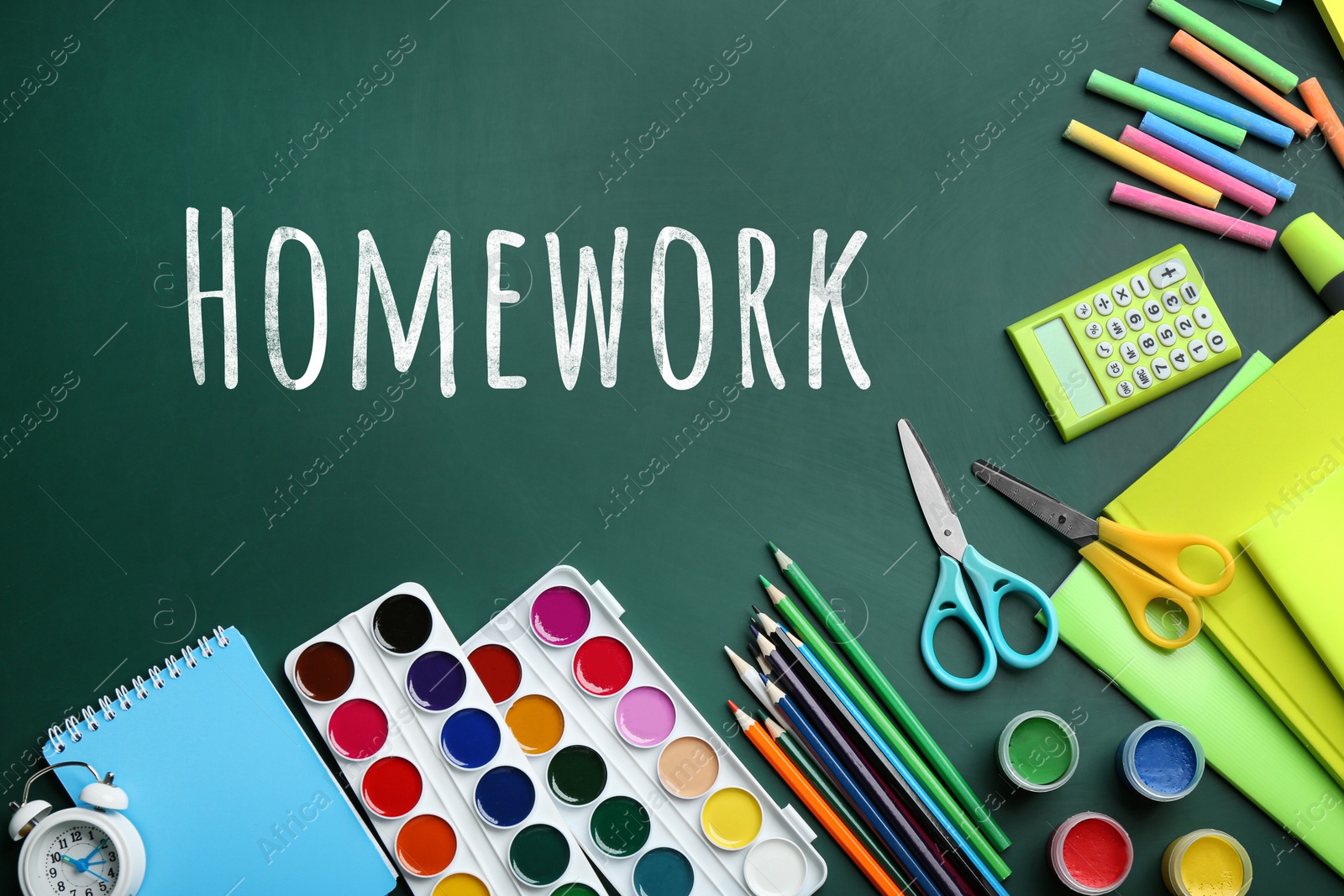 Image of Flat lay composition with school supplies and inscription HOMEWORK on chalkboard