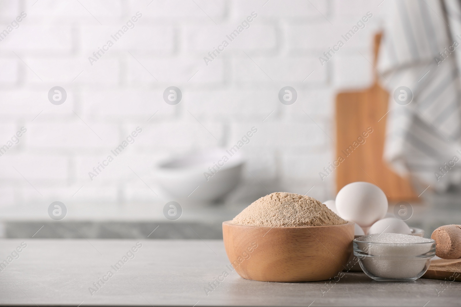 Photo of Bowl of buckwheat flour, sugar and eggs on table indoors, space for text