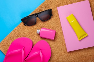 Photo of Flat lay composition with beach accessories on light blue background