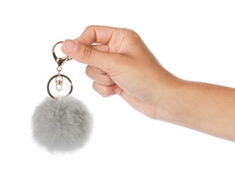 Photo of Woman holding gray faux fur keychain on white background, closeup