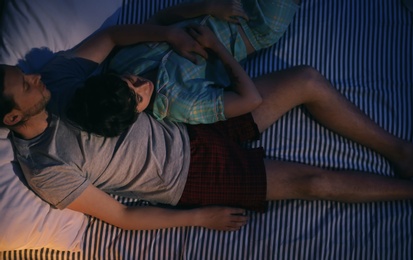 Photo of Young lovely couple sleeping in bed at home