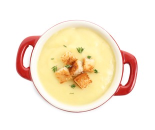 Photo of Tasty potato soup with croutons and rosemary in ceramic pot isolated on white, top view