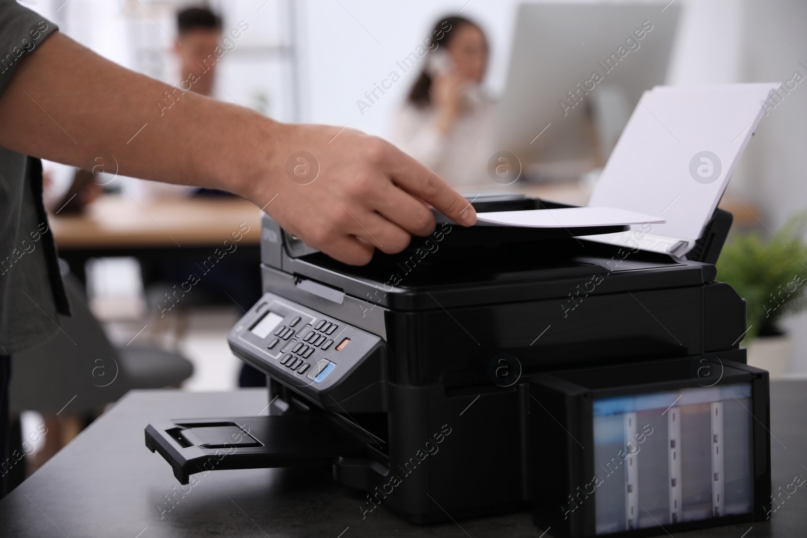 Photo of Employee using modern printer in office, closeup