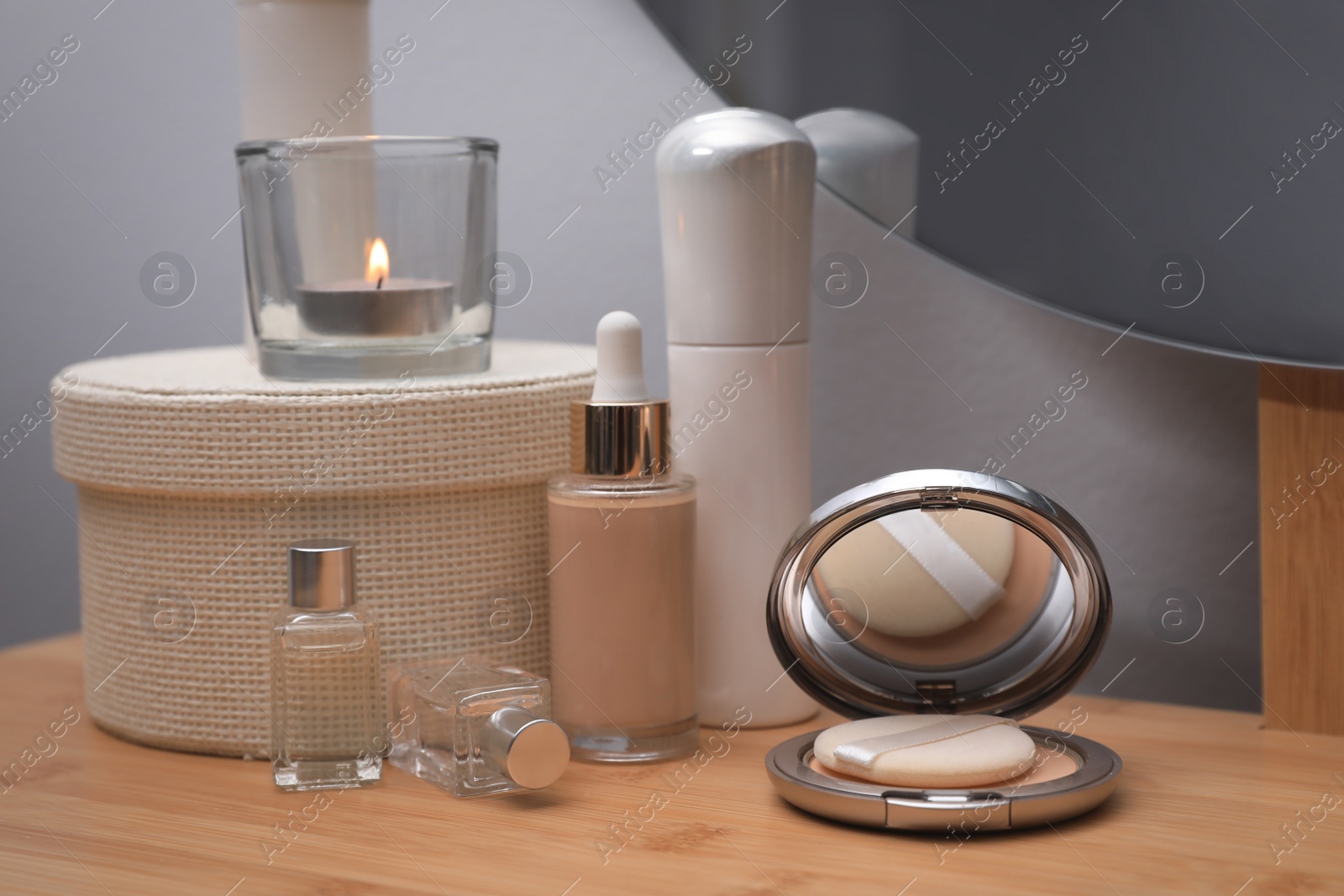 Photo of Different decorative cosmetic products on dressing table