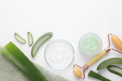 Photo of Flat lay composition with cosmetic products and cut aloe leaves on white background. Space for text