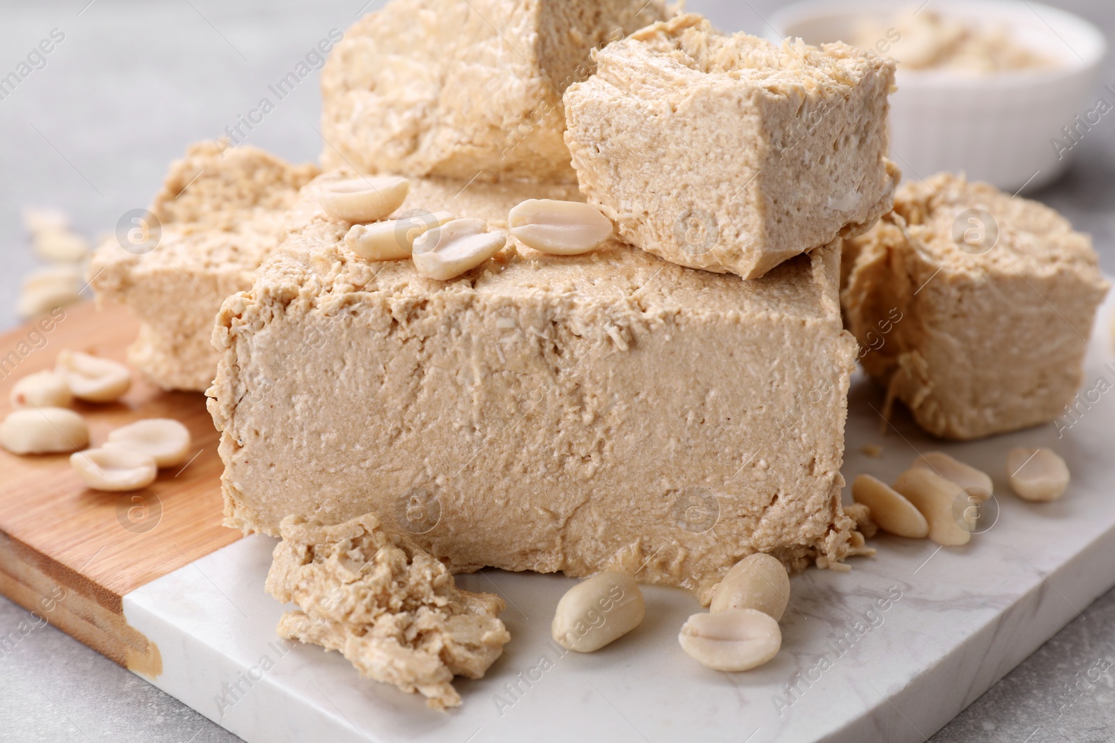 Photo of Pieces of tasty halva on table, closeup