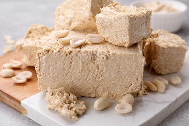 Pieces of tasty halva on table, closeup