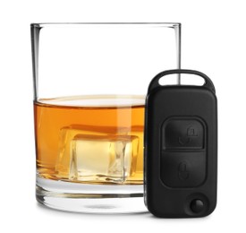 Glass of alcohol and car key isolated on white. Drunk driving concept