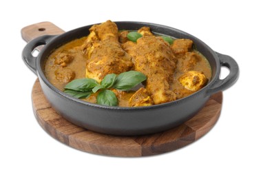 Delicious chicken with curry sauce and basil isolated on white