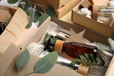Photo of Box with eco friendly personal care products on table, closeup