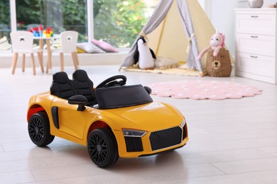 Photo of Yellow car in room at home. Child's toy