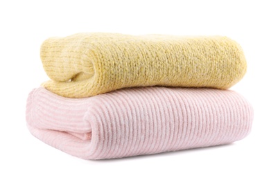 Stack of warm sweaters isolated on white