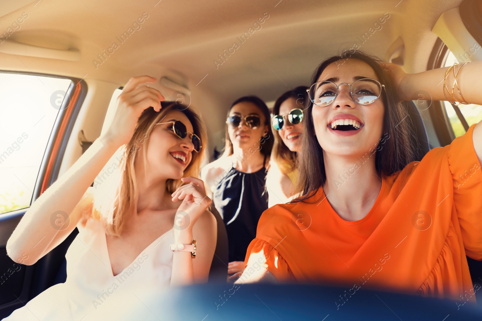 Photo of Happy beautiful young women together in car