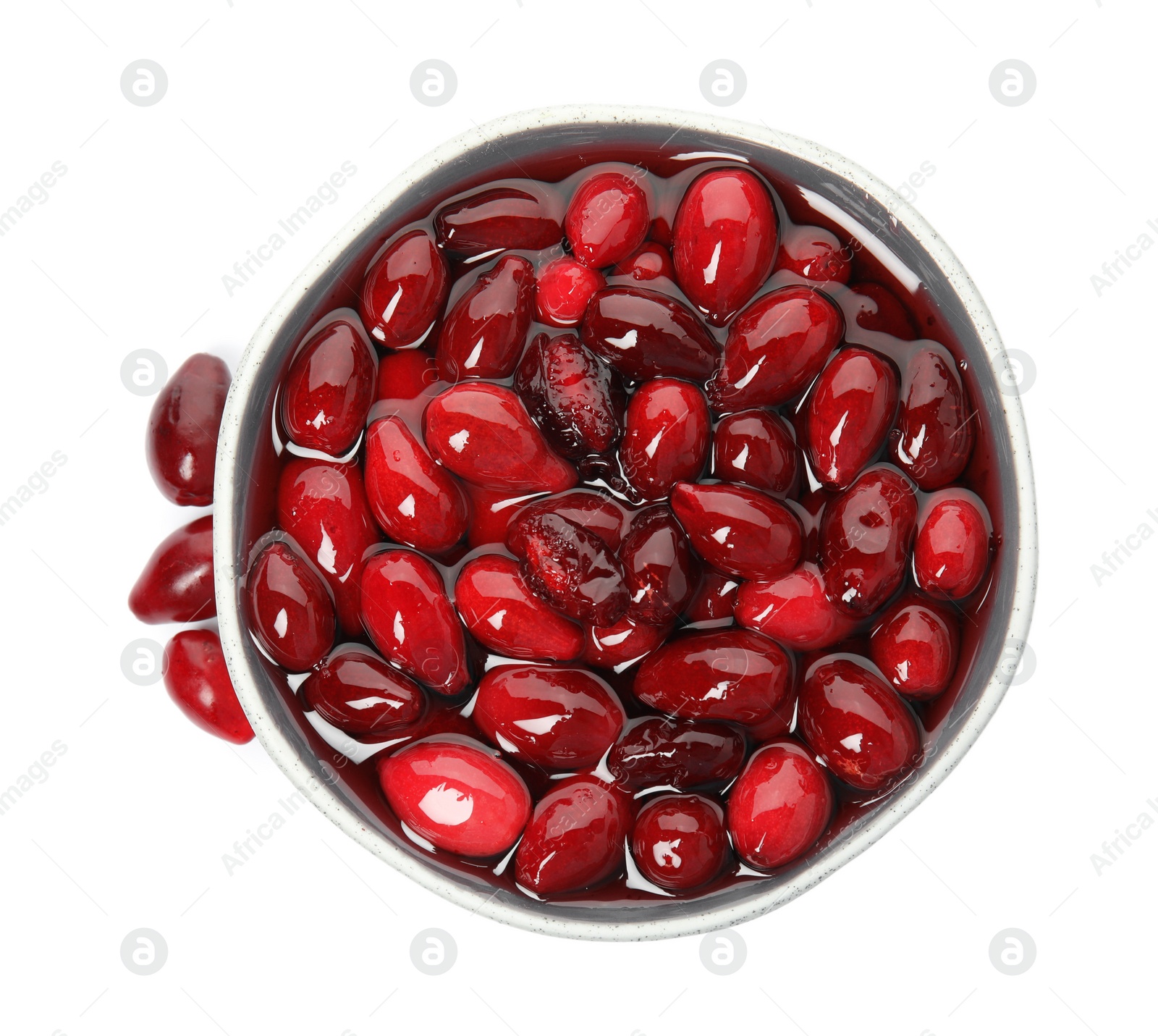 Photo of Delicious dogwood jam with berries and bowl on white background, top view