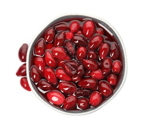 Photo of Delicious dogwood jam with berries and bowl on white background, top view