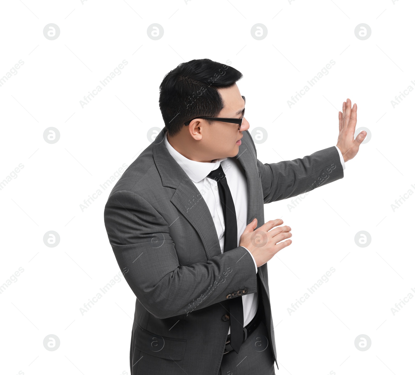 Photo of Scared businessman in suit posing on white background