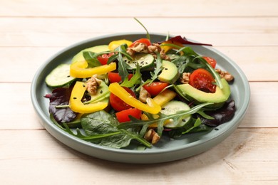 Balanced diet and vegetarian foods. Plate with different delicious products on wooden table, closeup