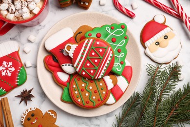 Flat lay composition with decorated Christmas cookies on white marble table