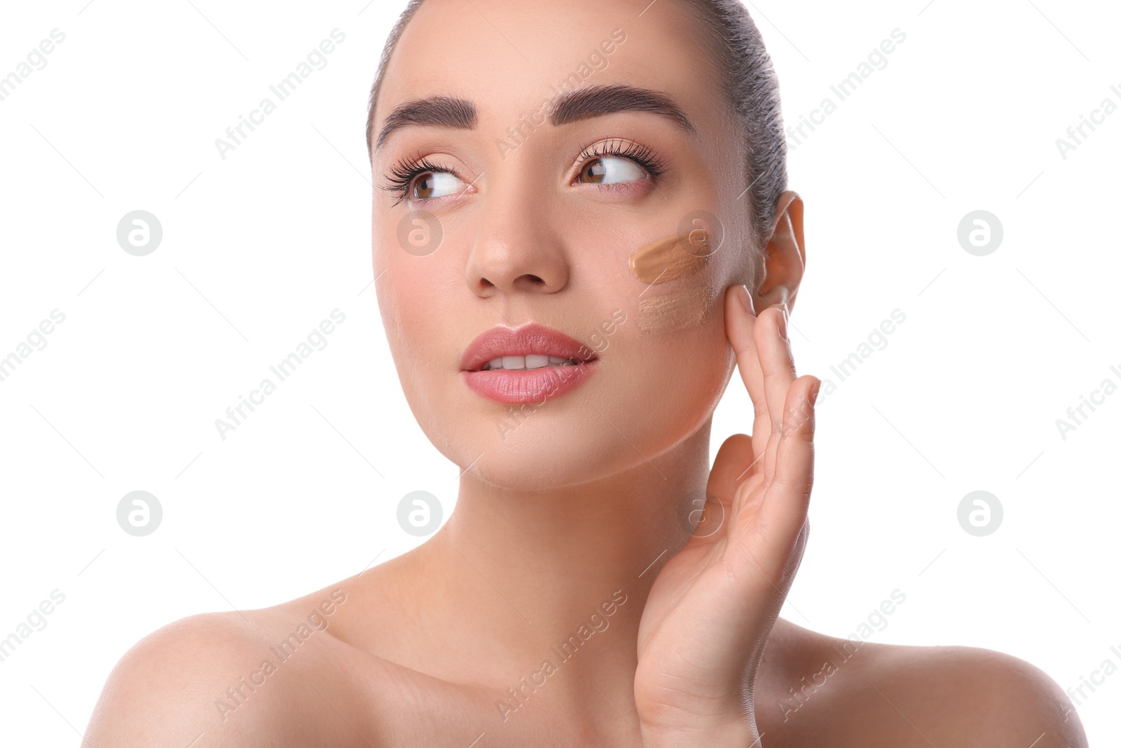 Photo of Woman with swatches of foundation on face against white background