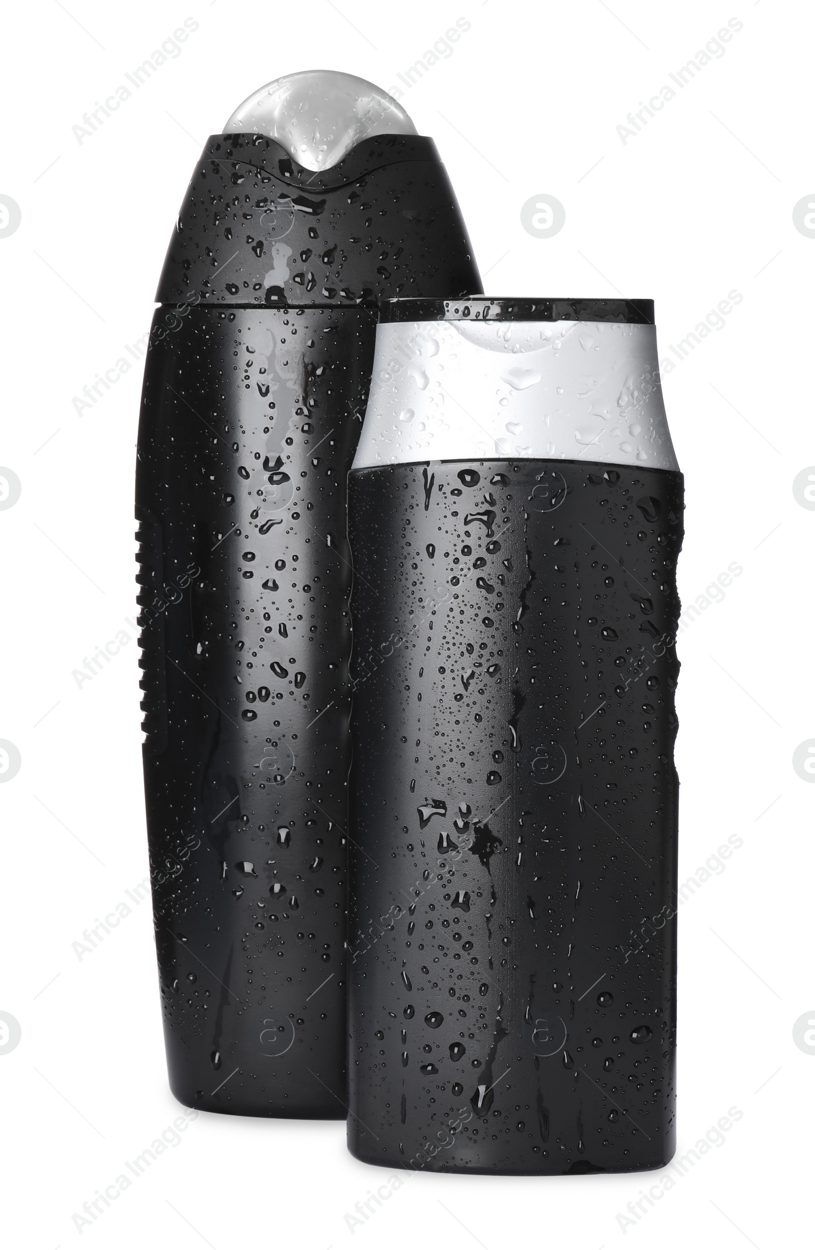 Photo of Black bottles covered with water drops isolated on white. Men's cosmetics