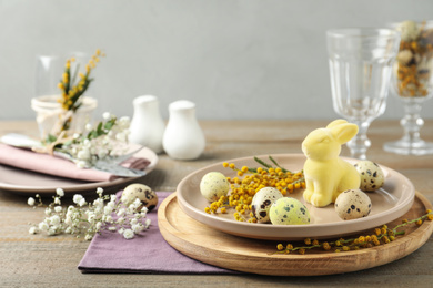 Photo of Festive Easter table setting with beautiful floral decor