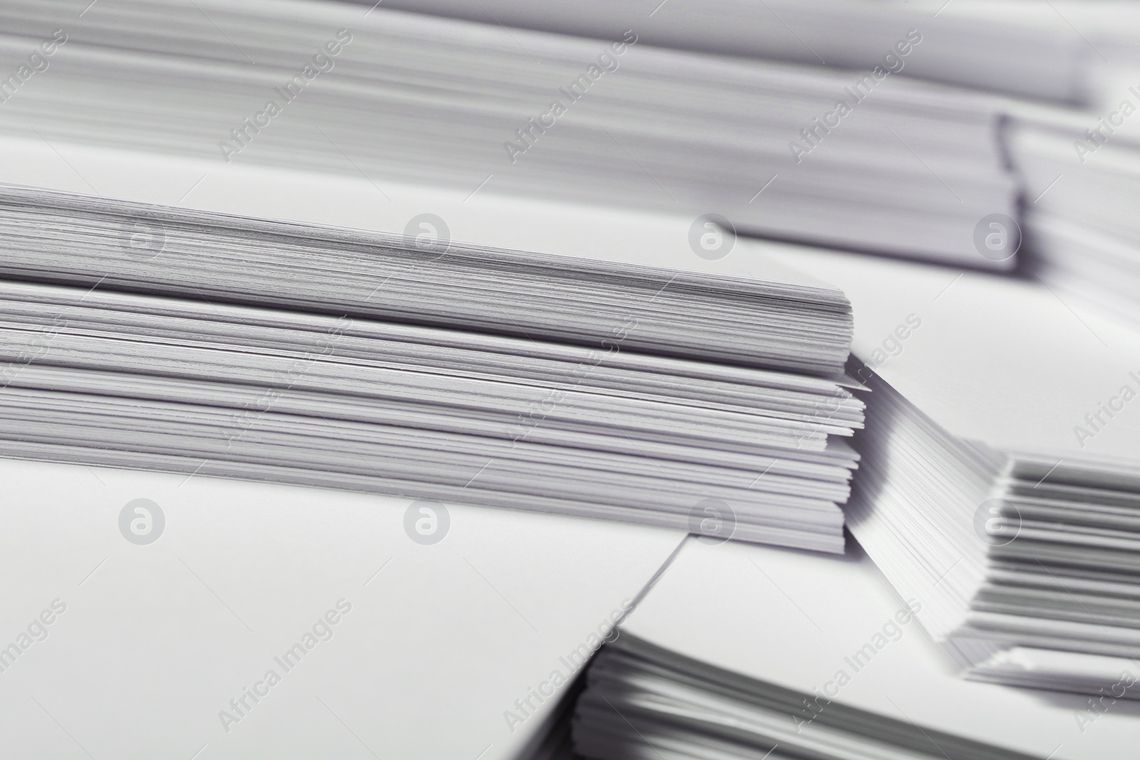 Photo of Stacks of paper sheets as background, closeup