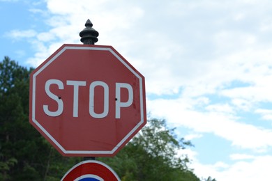 Photo of Post with Stop sign against blue sky