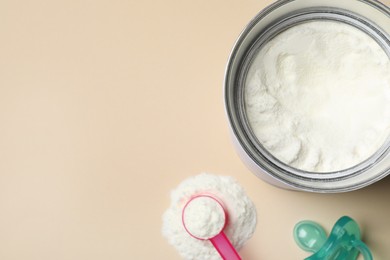 Photo of Flat lay composition with powdered infant formula on beige background, space for text. Baby milk