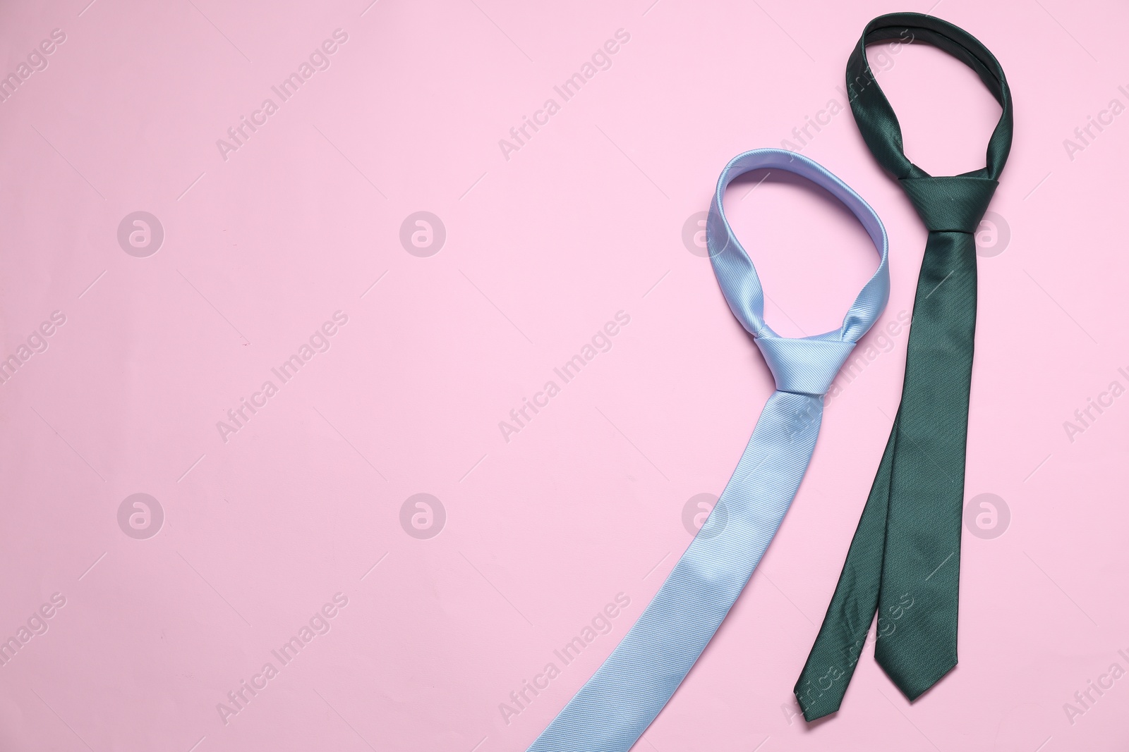 Photo of Neckties on pink background, above view. Space for text