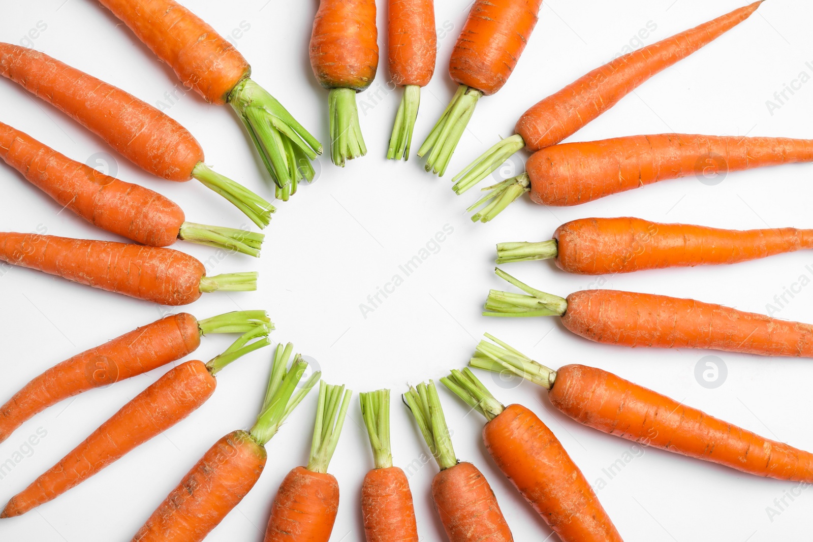 Photo of Frame made of ripe carrots on white background, top view. Space for text