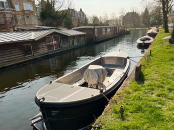 Photo of Beautiful city canal with moored boat on sunny spring day