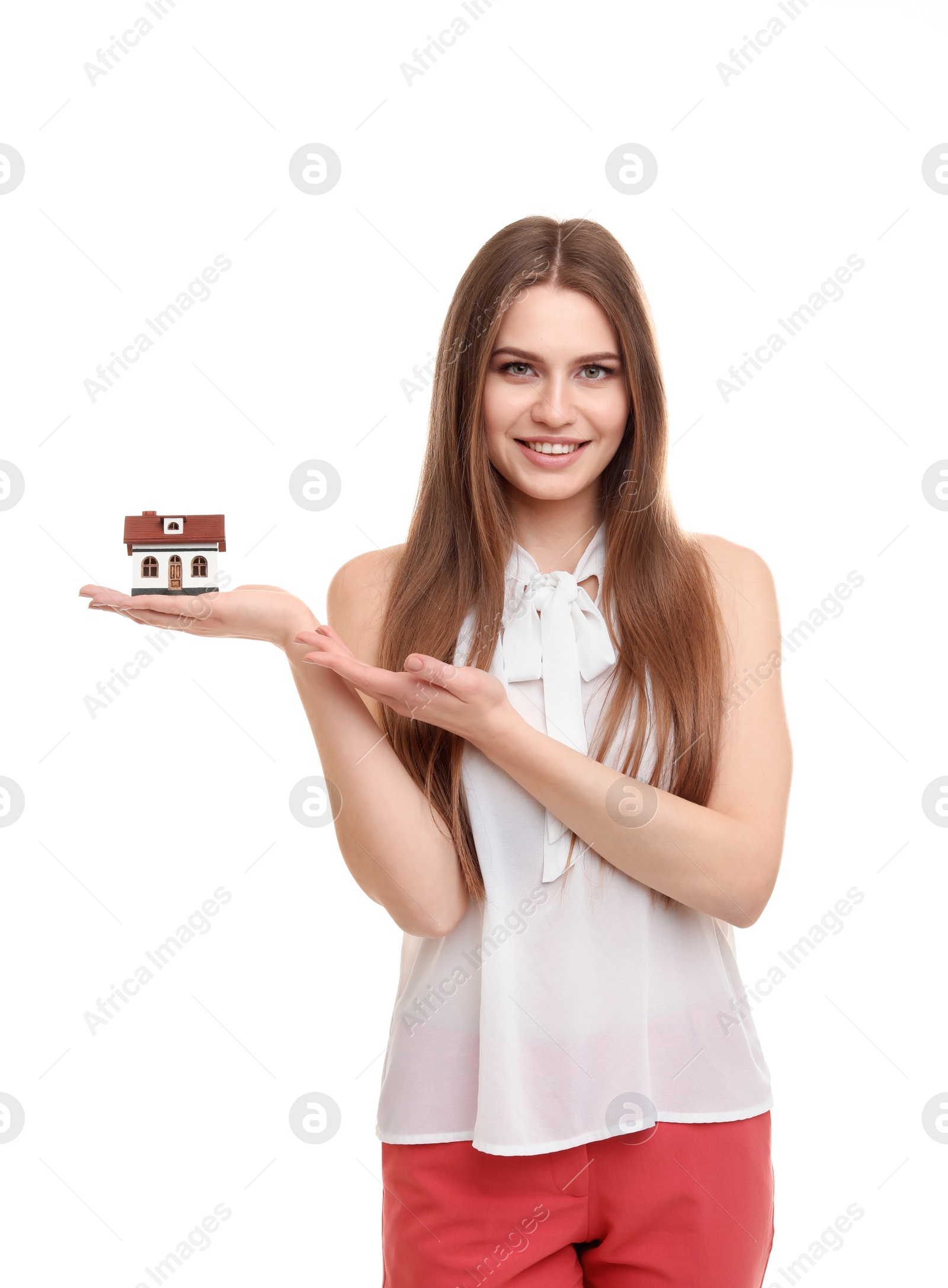 Photo of Beautiful real estate agent with house model on white background