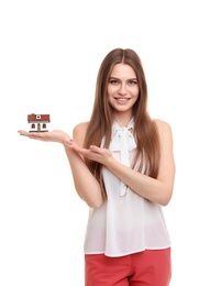Photo of Beautiful real estate agent with house model on white background